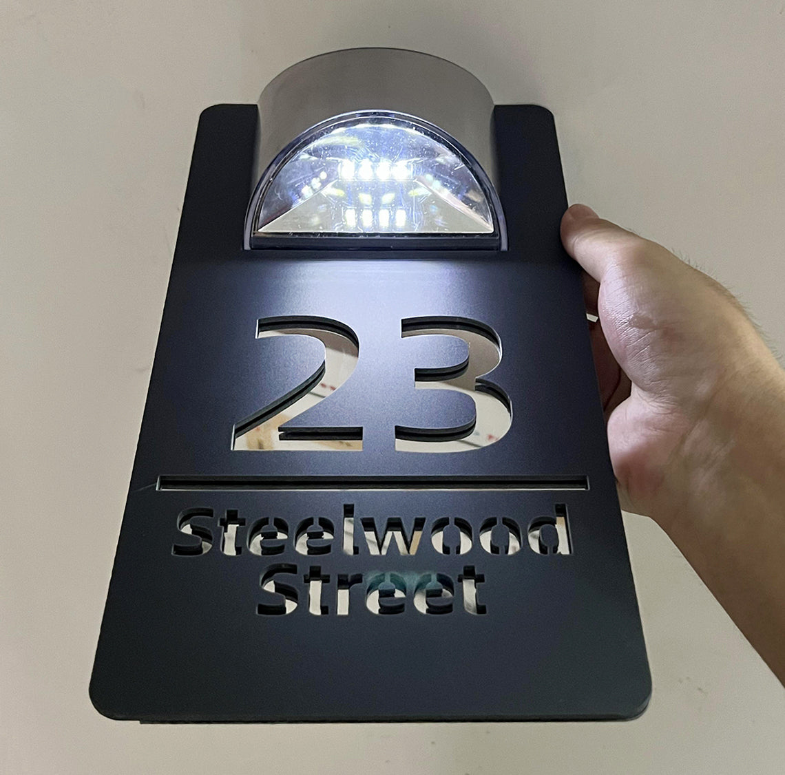 Solar powered house plaque
