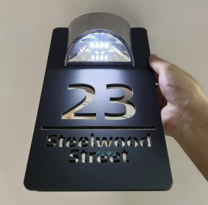 Solar powered house plaque